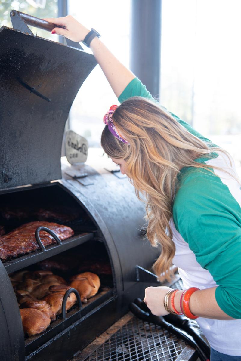 Mary Beth Brown checks on the barbecue